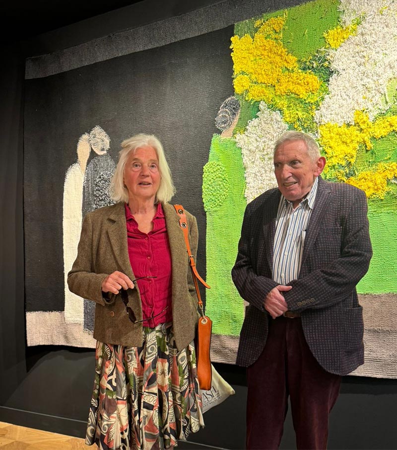 Frédérique Bachellerie and Péter Schönwald in front of Bernard Cathelin tapestry, ‘Katsura – Harmonie noire et verte’