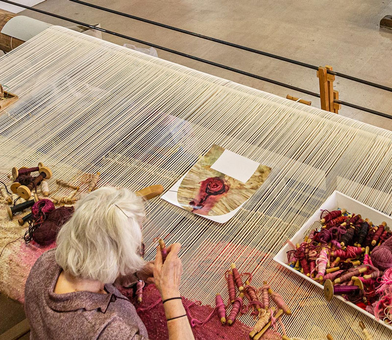 Frédérique Bachellerie and Péter Schönwald in front of Bernard Cathelin tapestry, ‘Katsura – Harmonie noire et verte’